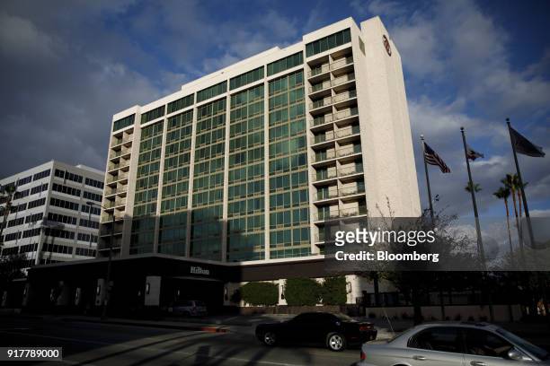 Vehicles pass in front of the Hilton Pasadena hotel in Pasadena, California, U.S., on Monday, Feb. 12, 2018. Hilton Worldwide Holdings Inc. Is...