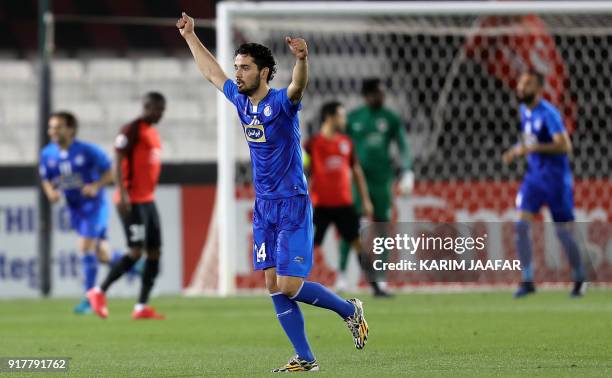 Iran's Esteghlal FC's Iranian midfielder Omid Noorafkan celebrates after Qatar's Al-Rayyan SC scored an own goal, during their Asian Champions League...