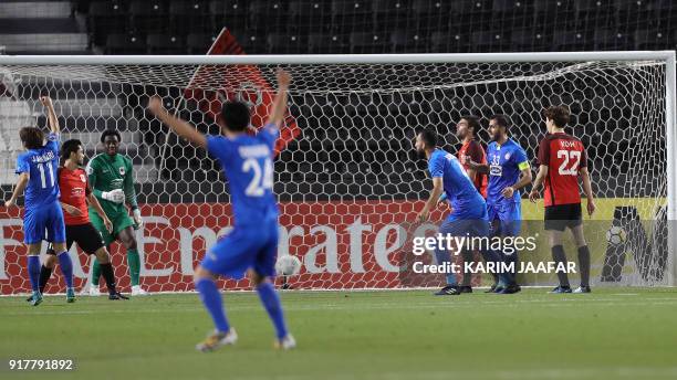 Players of Iran's Esteghlal FC celebrate after Qatar's Al-Rayyan SC scored an own goal, during their Asian Champions League football match at Jassim...