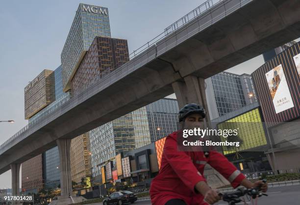 Cyclist rides past the MGM Cotai casino resort, developed by MGM China Holdings Ltd., in Macau, China, on Tuesday, Feb. 13, 2018. MGM Resorts...