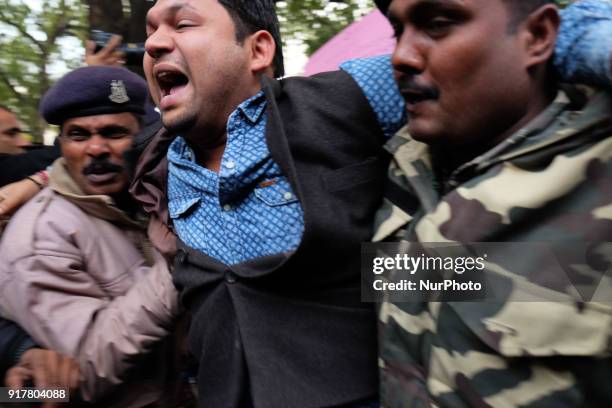 Protestor is dragged by Delhi police officials into a bus as Indian Youth Congress staged a protest demanding an apology for what it termed as...