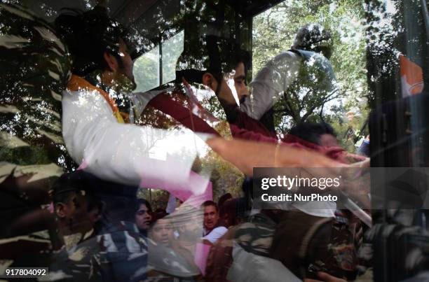 Protestors are pulled into a bus by security officials as Indian Youth Congress staged a protest demanding an apology for what it termed as...