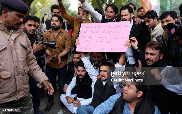 National secretary Indian Youth Congress Sitaram Lamba holds a placard demanding an apology from RSS Chief Mohan Bhagwat for his allegedly...