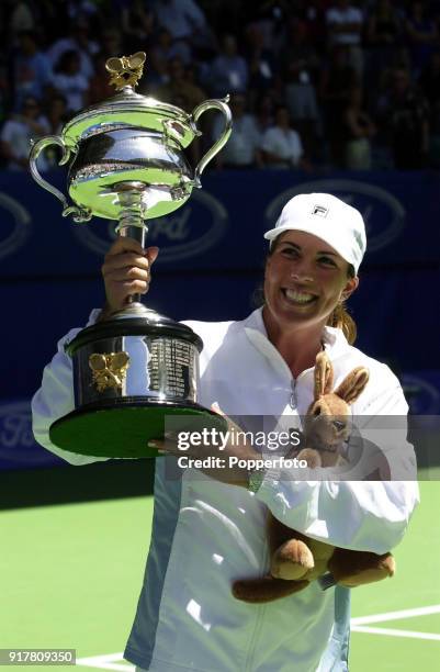 Jennifer Capriati from the US displays her trophy after her victory over World Number 1 tennis player Martina Hingis from Switzerland during their...