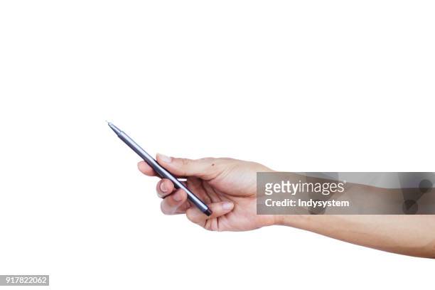close-up of hand holding pen against white background - pen stock pictures, royalty-free photos & images