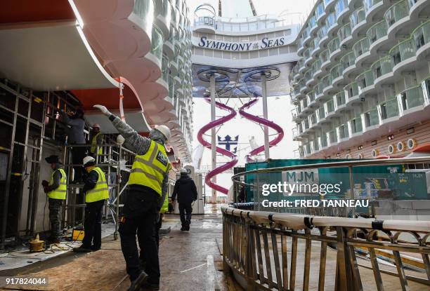 Welders work in US shipowner Royal Caribbeans new Oasis-class cruise ship, Symphony of the Seas, the largest passenger ship ever to be constructed by...