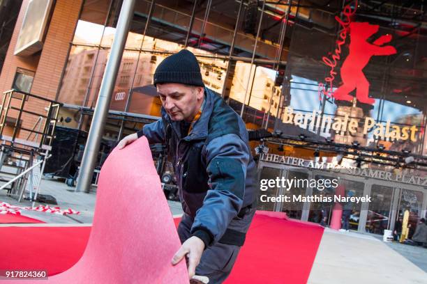 Worker rolls out the red carpet at the Berlinale Palace prior to the 68th Berlinale International Film Festival on February 13, 2018 in Berlin,...