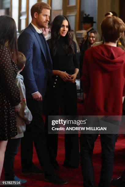 Britain's Prince Harry and his fiancée US actress Meghan Markle attend a reception for young people in the Palace of Holyroodhouse in Edinburgh,...