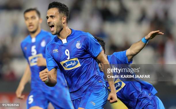 Esteghlal FC's Iranian forward Ali Ghorbani celebrates with his teammates after scoring a goal against Al-Rayyan SC during their Asian Champions...