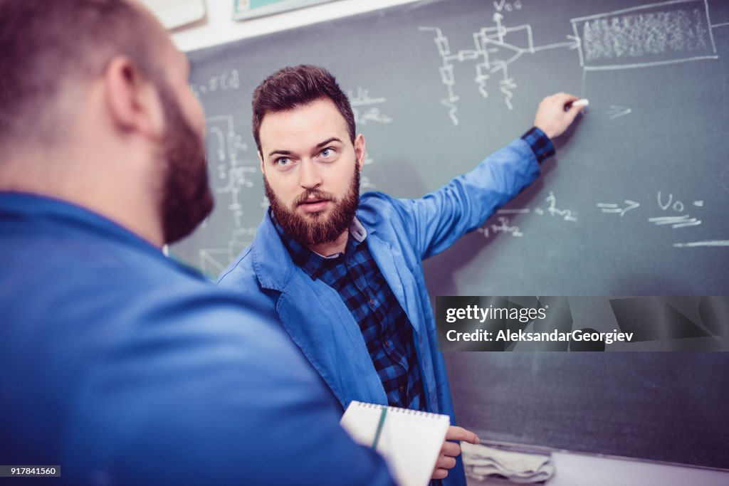 Two Engineers Discussing About Problem in the Office