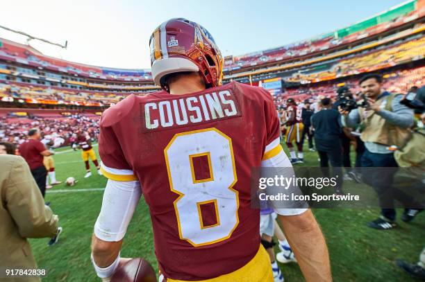 Washington Redskins quarterback Kirk Cousins celebrates with fans as he jogs back to the locker room after a NFL football game between the San...