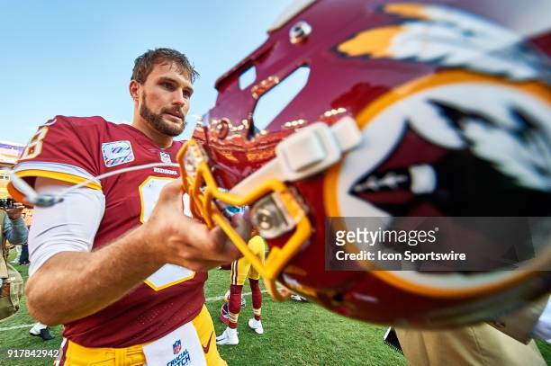 Washington Redskins quarterback Kirk Cousins takes his helmet off as he walks back to the locker room after a NFL football game between the San...