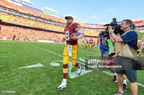 Washington Redskins quarterback Kirk Cousins celebrates with fans as he jogs back to the locker room after a NFL football game between the San...