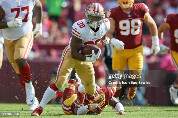 San Francisco 49ers running back Carlos Hyde battles with Washington Redskins linebacker Zach Brown during a NFL football game between the San...