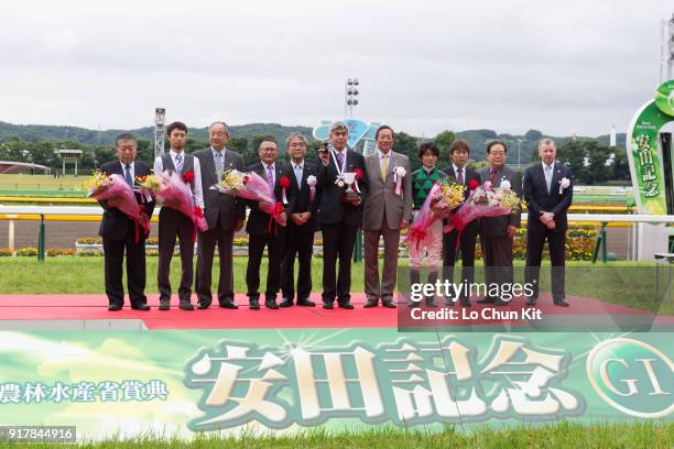 Jockey Yoshitomi Shibata, trainer Naosuke Sugai and owner Akatsuki Yamatoya at the trophy presentation ceremony after Just A Way winning the Yasuda...