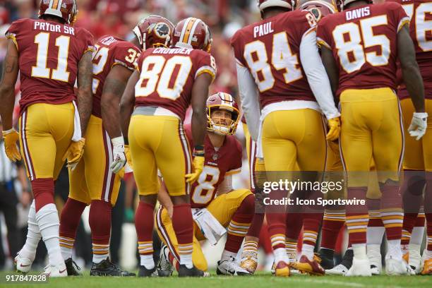 Washington Redskins quarterback Kirk Cousins talks to his teammates in a huddle during a NFL football game between the San Francisco 49ers and the...