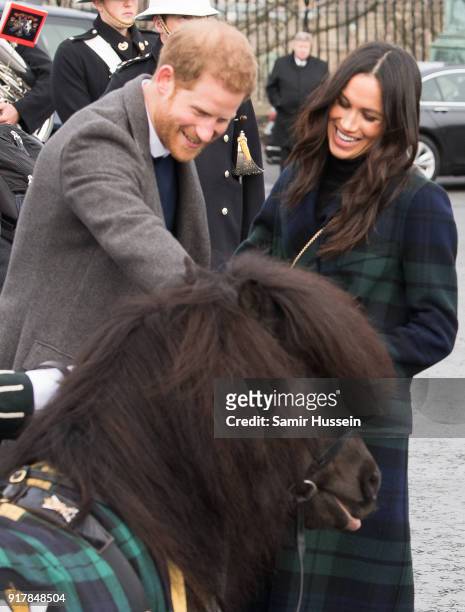 Meghan Markle and Prince Harry meet a Shetland pony as they visit Edinburgh Castle during a visit to Scotland on February 13, 2018 in Edinburgh,...