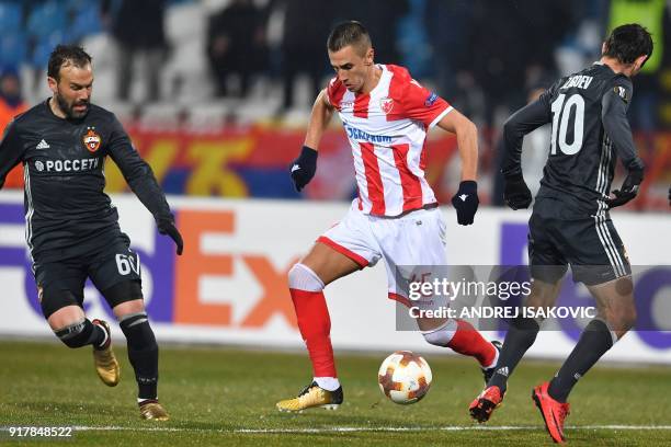 Red Star's Aleksandar Pesic fights for the ball with CSKA's Bibras Natcho and CSKA's Alan Dzagoev during the Europa League Round of 32 first leg...