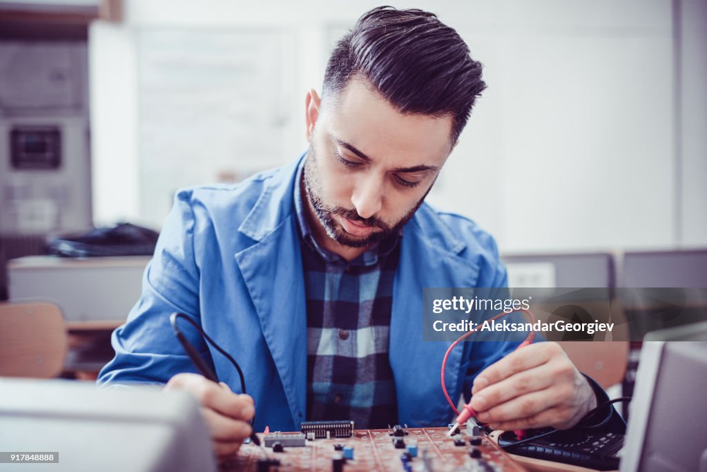 Young Handsome Engineer Measuring in the Office