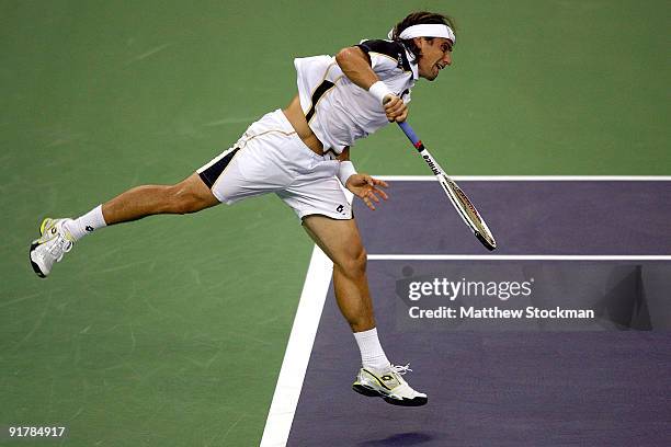 David Ferrer of Spain serves to Richard Gasquet of France during day two of the 2009 Shanghai ATP Masters 1000 at Qi Zhong Tennis Centre on October...