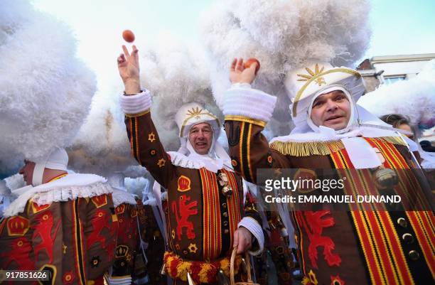 Performers dressed as a "Gilles", the oldest and principal participants in the Carnival of Binche in Belgium, wearing their white feather hat and...