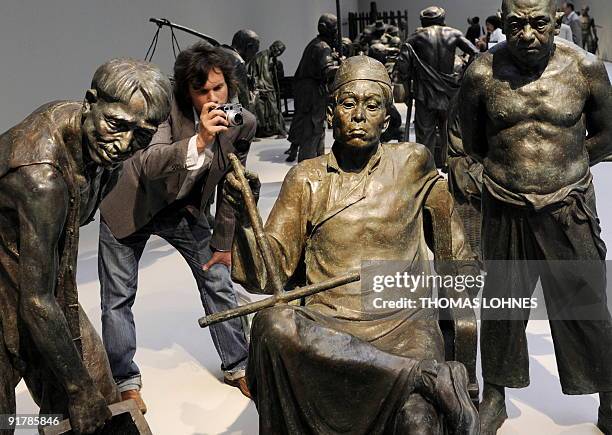 Man photographs sculptures of the exhibition "Art for millions - 100 sculptures from the Mao era" at the Schirm gallery in the central German city of...