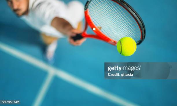 tennis game at night. - taking a shot sport stock pictures, royalty-free photos & images