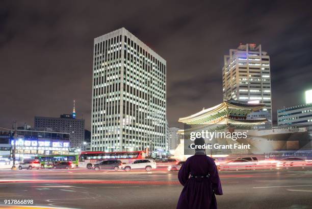 korean man at night at city. - namdaemun gate stock pictures, royalty-free photos & images