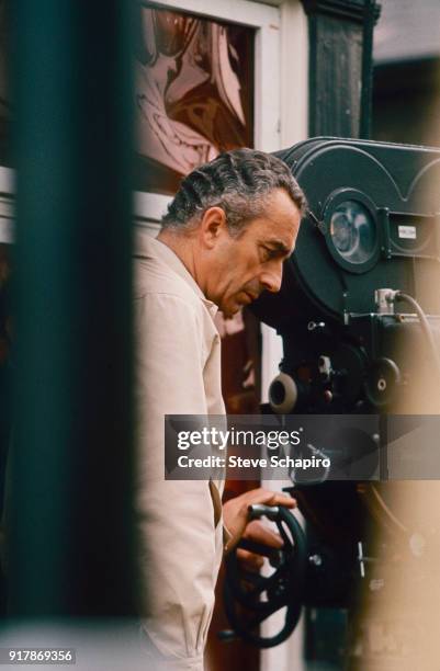 Italian film director Michelangelo Antonioni stands behind the camera on the set of his film 'Blow-Up,' London, England, 1965.