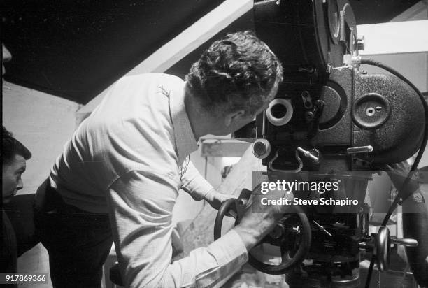 Italian film director Michelangelo Antonioni stands behind the camera on the set of his film 'Blow-Up,' London, England, 1965.