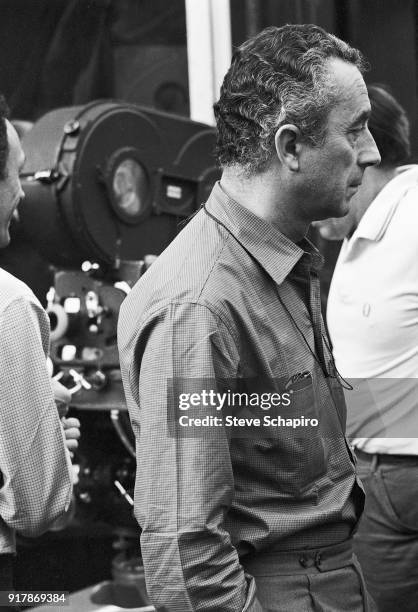 Italian film director Michelangelo Antonioni , along with unidentified crew members, stands behind the camera on the set of his film 'Blow-Up,'...