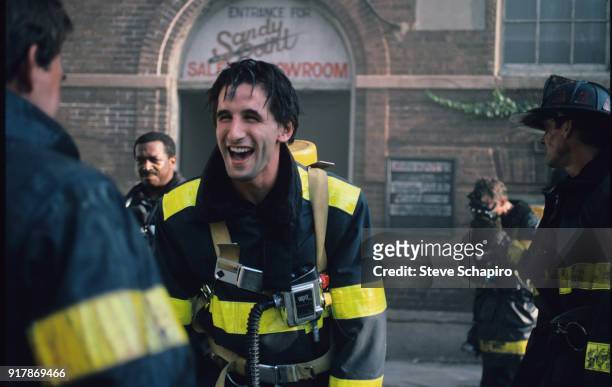American actor William Baldwin laughs with fellow cast members on the set of the film 'Backdraft' , Los Angeles, California, 1990.