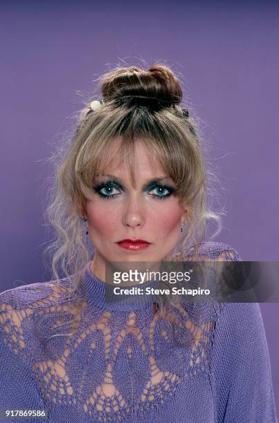 Portrait of American actress Susan Blakely, in a violet crocheted top, as she poses against a violet background, Los Angeles, California, 1979.