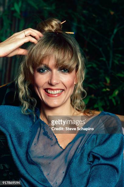 Portrait of American actress Susan Blakely, one hand on her head, as she smiles and poses outdoors, Los Angeles, California, 1979.