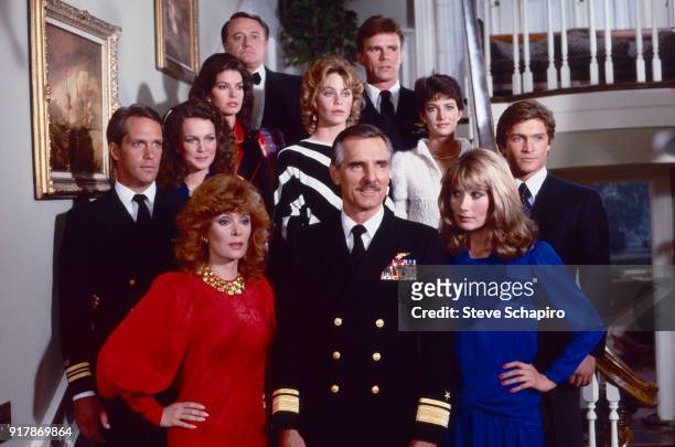 Portrait of the cast of the television series 'Emerald Point NAS' as they pose on a staircase, Los Angeles, California, 1983. Pictured are, fore from...