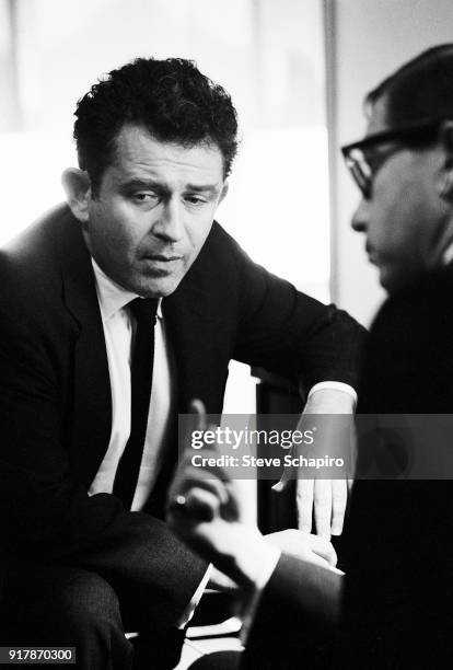 Backstage at Carnegie Hall, American author Norman Mailer speaks with unidentified others, New York, New York, May 31, 1963.