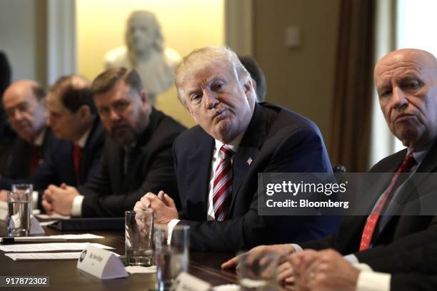 President Donald Trump, center, listens during a meeting with bipartisan members of Congress on trade in the Cabinet Room of the White House in...