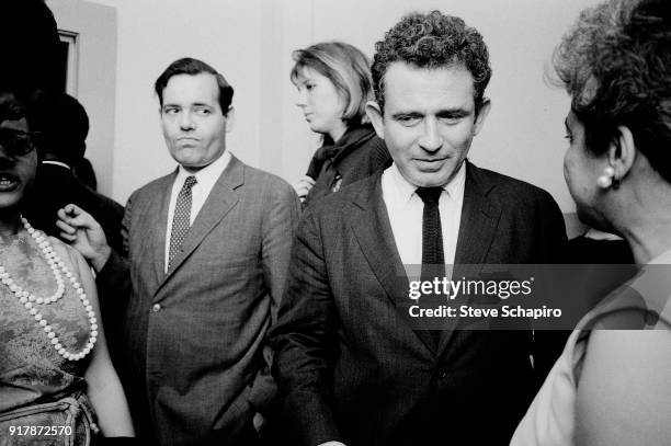 Backstage at Carnegie Hall, American author Norman Mailer speaks with unidentified others, New York, New York, May 31, 1963.