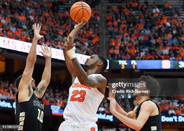 Frank Howard of the Syracuse Orange shoots the ball between Mitchell Wilbekin and Donovan Mitchell of the Wake Forest Demon Deacons during the second...
