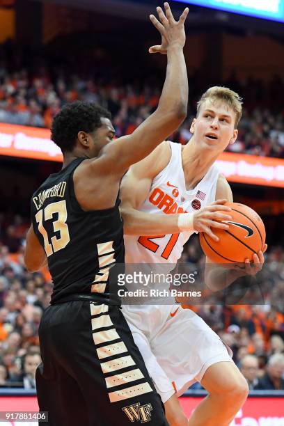 Marek Dolezaj of the Syracuse Orange drives to the basket against the defense of Bryant Crawford of the Wake Forest Demon Deacons during the second...