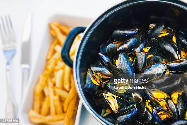 a serving of mussels with chips.  - mussels bildbanksfoton och bilder
