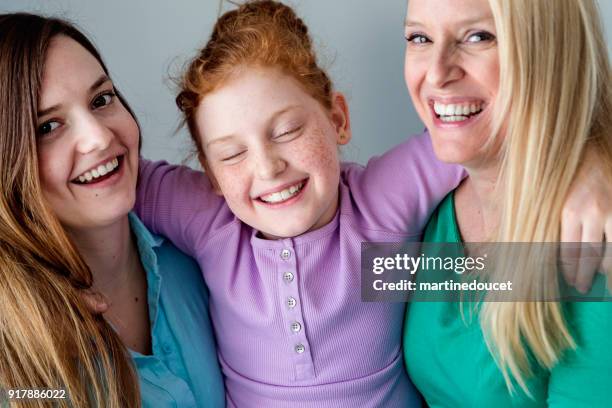 family portrait of mother and daughters close-up. - ginger bush stock pictures, royalty-free photos & images
