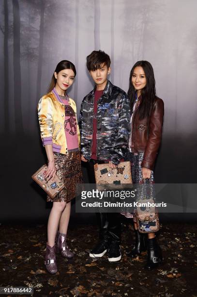 Janice Man, Allen Ren JiaLun and Aimee Yun Yun Sun attend the Coach Fall 2018 Runway Show at Basketball City on February 13, 2018 in New York City.