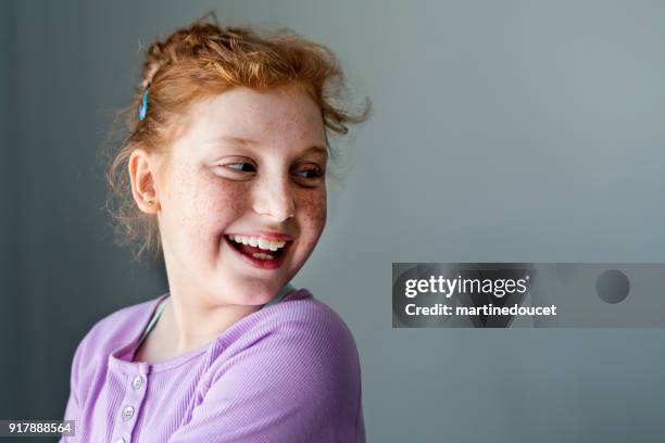 Cute and expressive preteen girl with redhead portrait.