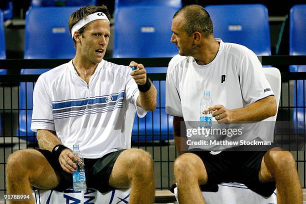 Robert Lindstedt of Sweden confer with Martin Damm of the Czech Republic between games while Michal Mertinak of Slovakia and Frantisek Cermak of the...