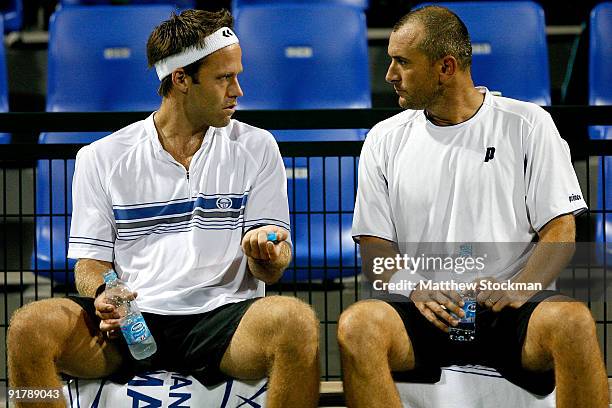 Robert Lindstedt of Sweden confer with Martin Damm of the Czech Republic between games while Michal Mertinak of Slovakia and Frantisek Cermak of the...