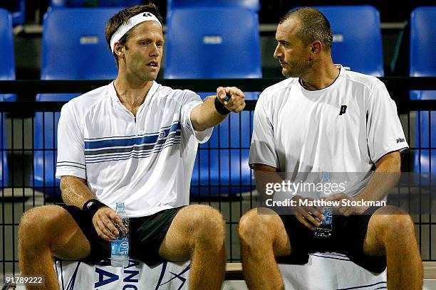 Robert Lindstedt of Sweden confer with Martin Damm of the Czech Republic between games while Michal Mertinak of Slovakia and Frantisek Cermak of the...