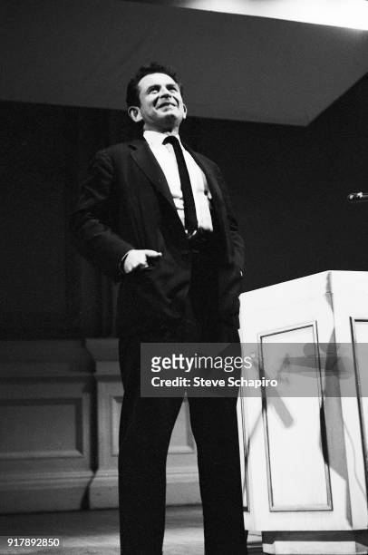 Hands in his pockets, American author Norman Mailer speaks onstage at Carnegie Hall, New York, New York, May 31, 1963.