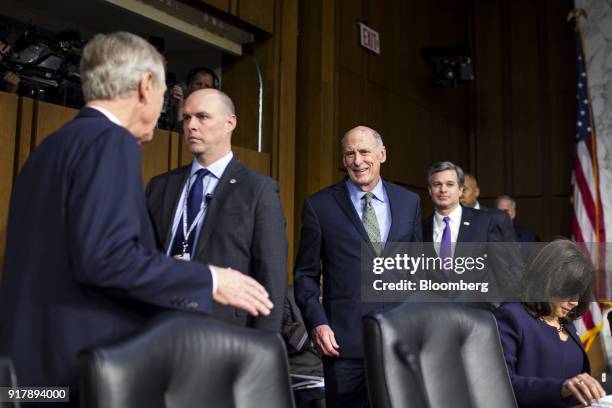Dan Coats, director of national intelligence, center, and Christopher Wray, director of the Federal Bureau of Investigation , right, arrive to...