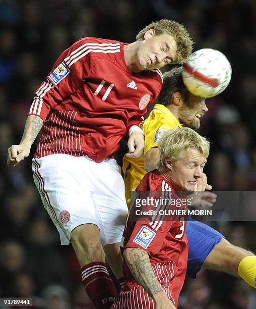 Denmark's Nickals Bendtner struggles for the ball with Sweden's Kim Kallstrom during the World Cup 2010 qualifying match on October 10, 2009 at the...